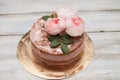 Homemade buttercream round cake with pink rose flowers on top, valentines love concept